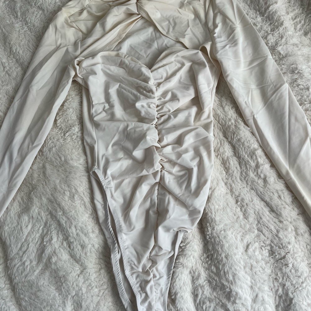 White ruched-like bodysuit with heart shaped cut out detailing